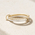 Duo Ring laying down in a fuzy/sandy background