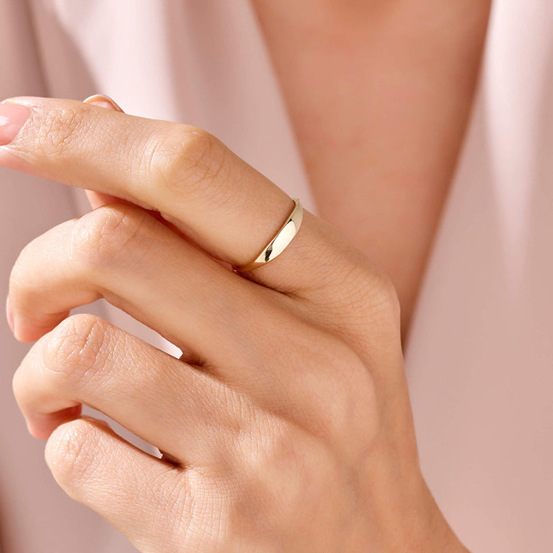 Person wearing Lune ring with close up shot of hand with person body in background