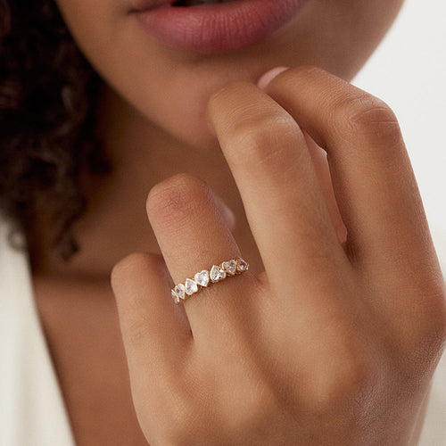 Person wearing Amour ring with part of face and hand showing